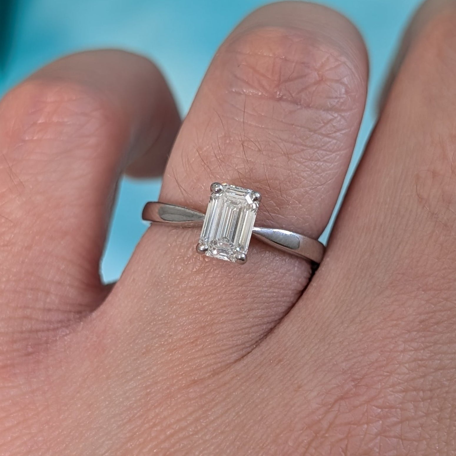 Emerald cut diamond solitaire ring in platinum, 0.93ct