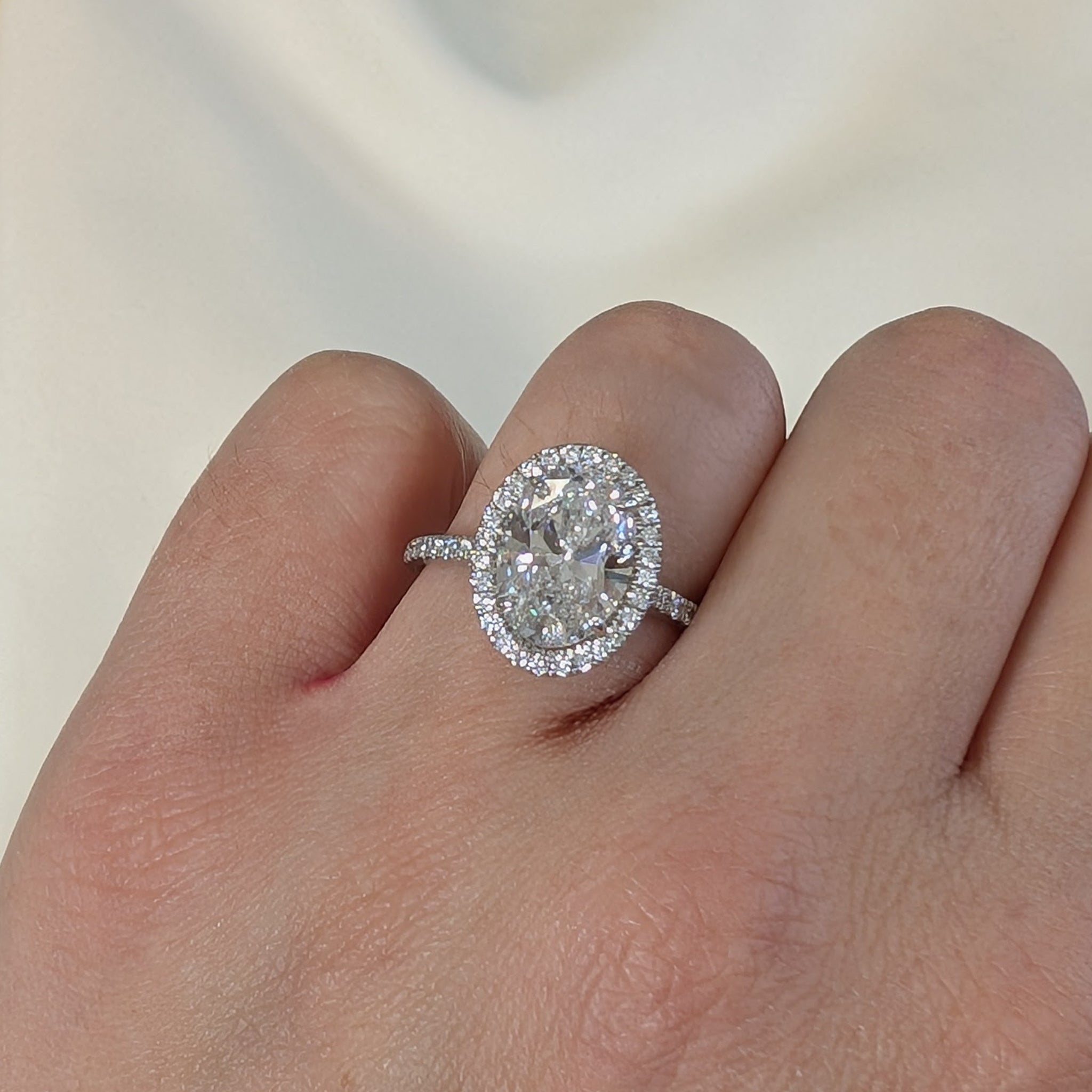 Lab grown oval diamond halo cluster ring in platinum, 3.41ct