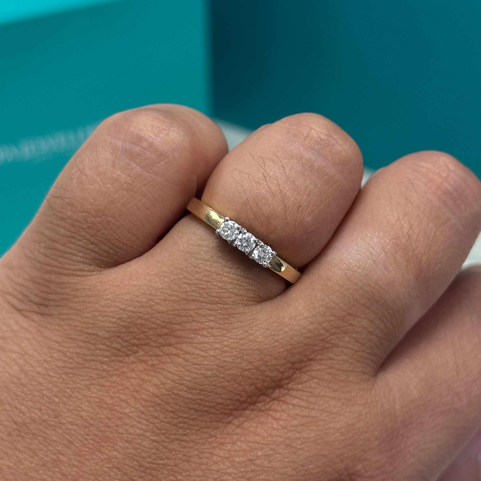 Brilliant cut diamond three stone ring in 18ct gold