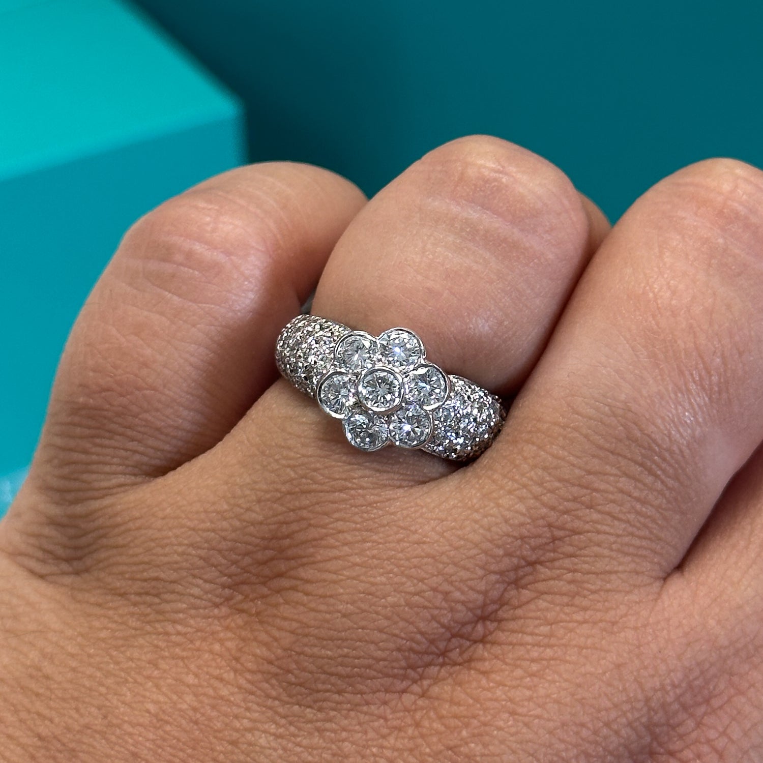 Diamond floral cluster ring with diamond set shoulders in 18ct white gold, 1.70ct