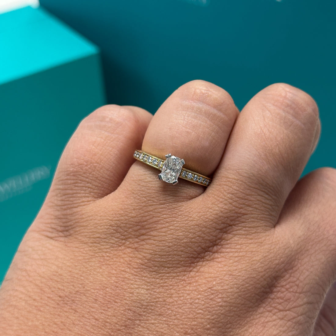 Phoenix cut diamond ring with diamond set shoulders in 18ct yellow gold, 0.72ct