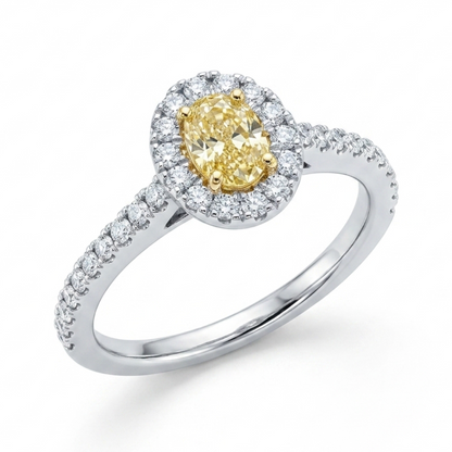 Oval yellow diamond and diamond halo cluster ring in platinum and 18ct gold