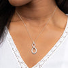 Double oval pendant with textured links in silver.