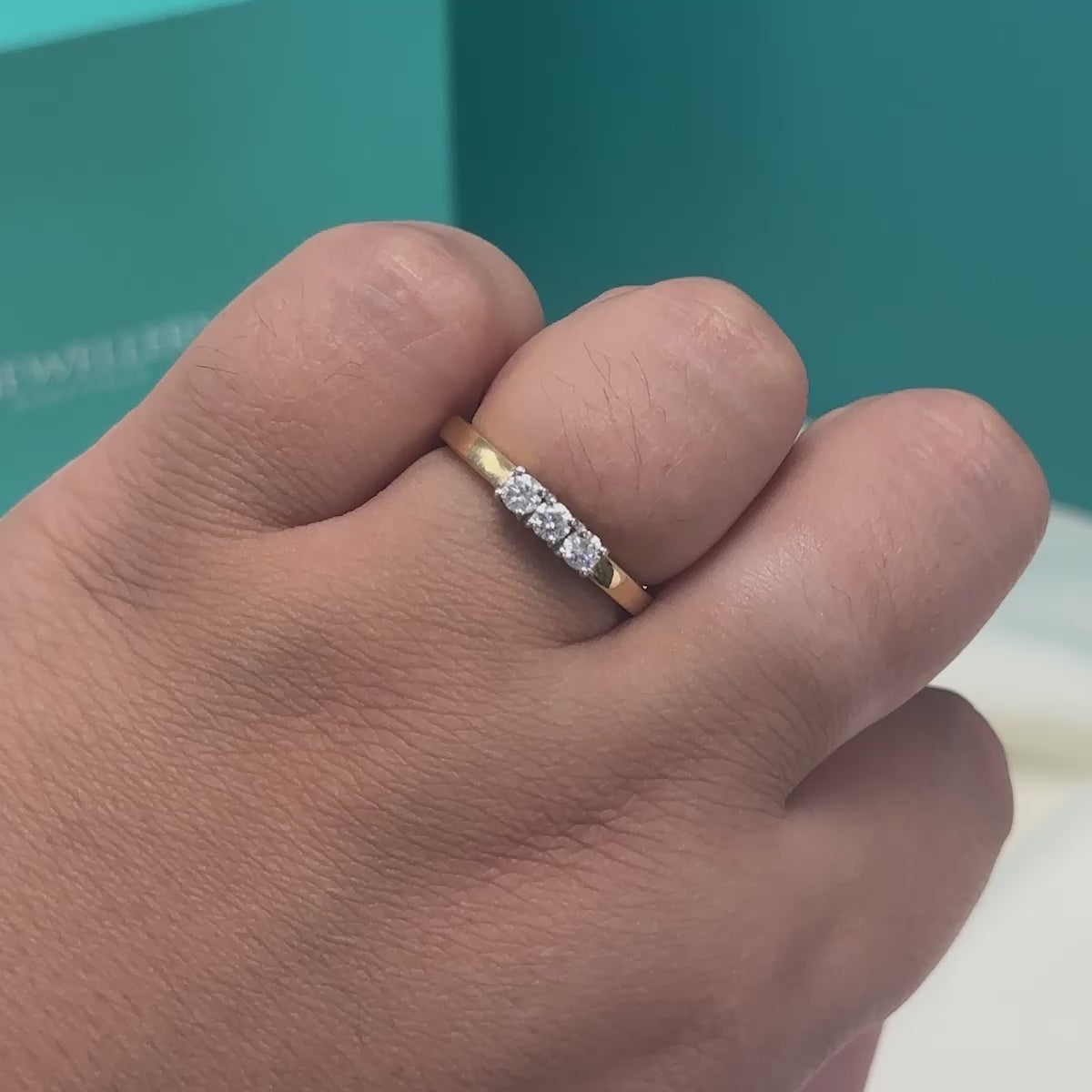 Brilliant cut diamond three stone ring in 18ct gold