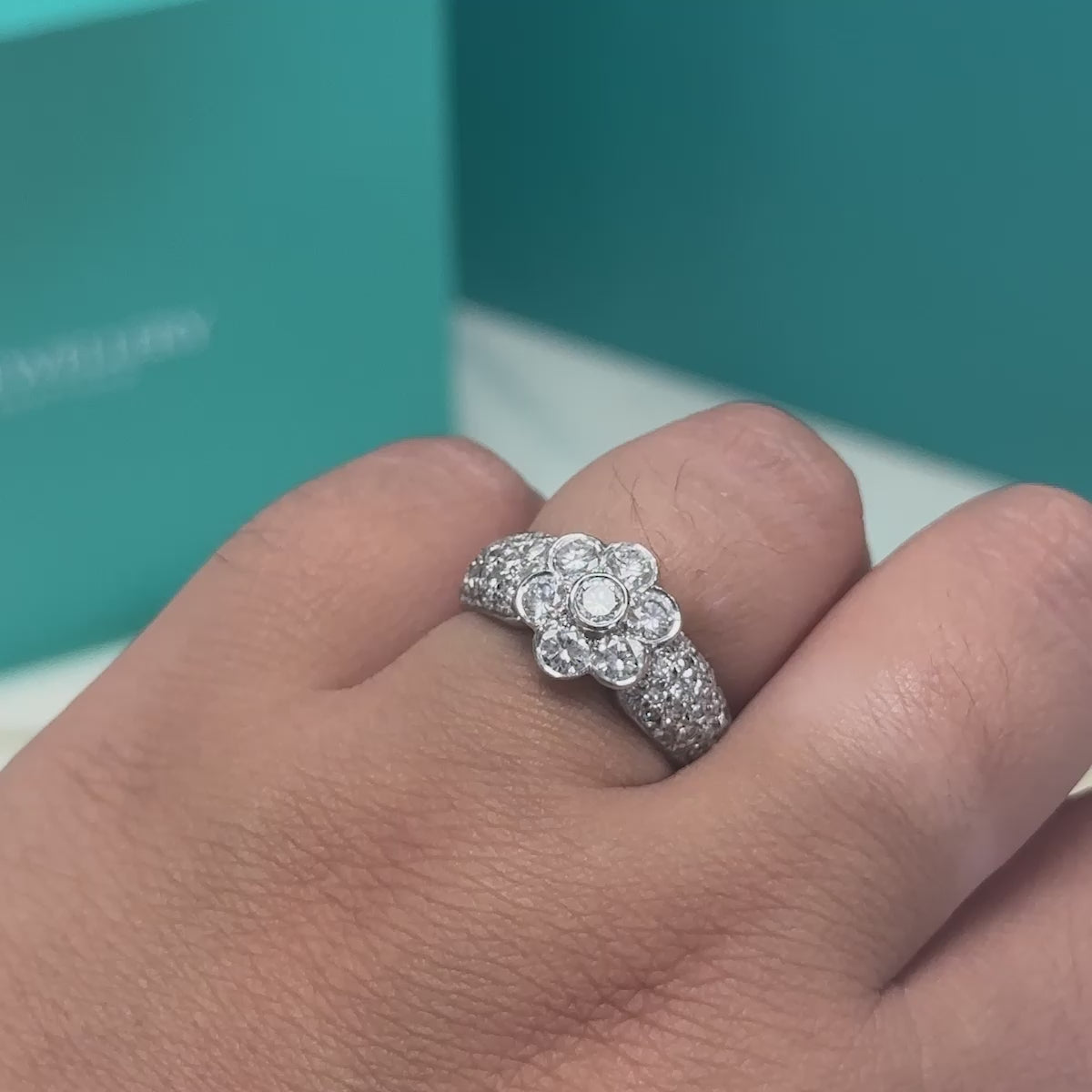 Diamond floral cluster ring with diamond set shoulders in 18ct white gold, 1.70ct