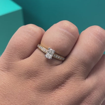 Phoenix cut diamond ring with diamond set shoulders in 18ct yellow gold, 0.72ct