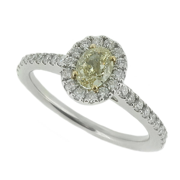 Oval yellow diamond and diamond halo cluster ring in platinum and 18ct gold