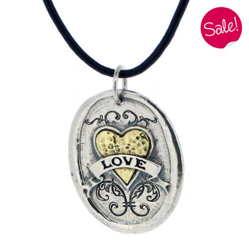 Large oval 'love' pendant and cord in silver and brass